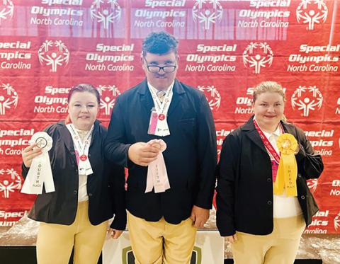Photos courtesy of High Lonesome Therapeutic Equestrian Center  Showmanship award winners in the Special Olympics at the Tryon International Equestrian Center in Mill Spring from Sept. 22-24 were (from left) Lana Foster, who won fourth place riding Daniel; Joshua Mills, who took fifth place atop Little Bob; and Christina Zimmerer, who received the third-place spot with Daniel. Foster was also selected to represent all the athletes at the equestrian games for opening and awards ceremony at Saturday Night Lig