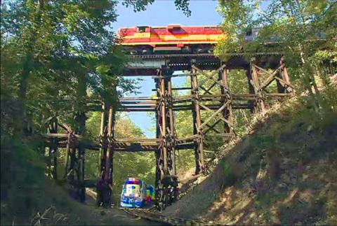 Two trains crossing the wooden trestle crossover spot at the Hiwassee Loop.