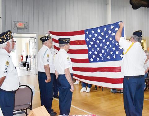 American Legion Post 96 of Murphy prepares to fold a U.S. flag, which will be presented to Myers in a display case at a later date.