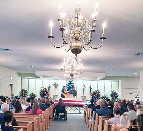 Anngee Quinones-Belian/Staff Correspondent Andrews Police Chief Rocky Burrell’s life was celebrated by a packed chapel in Ivie Funeral Home at a memorial service Monday. Family, friends, law enforcement and local residents attended the service, which was officiated by the Rev. Chris Rumfelt.