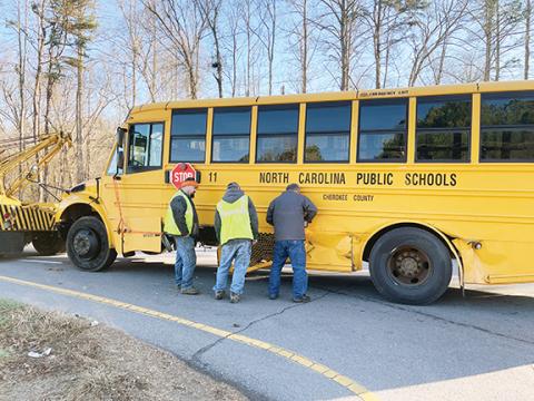 Randy Foster/editor@cherokeescout.com Maintenance workers from Cherokee County Schools prepare a school bus to be towed from a crash scene just off of U.S. 64 West in Ranger on Monday afternoon.