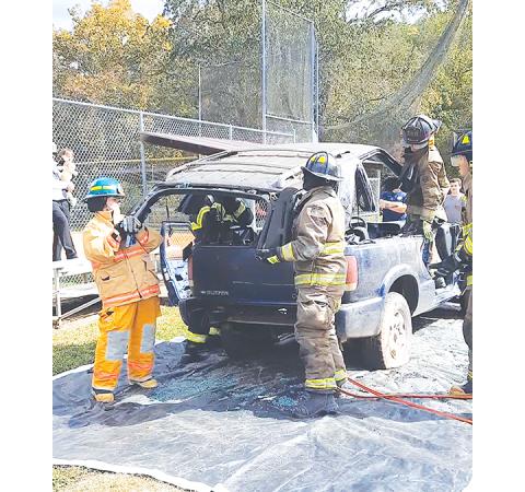 Photos by Anngee Quinones-Belian/ Staff Correspondent Firefighters use heavy tools to perform lifesaving tasks on the scene.