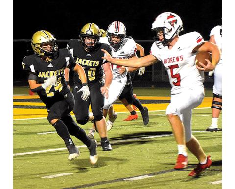 Andrews running back Dalton Rose (5) prepares to straight arm Hayesville’s Michael Mauney (24) as Rose angles for the end zone. 
