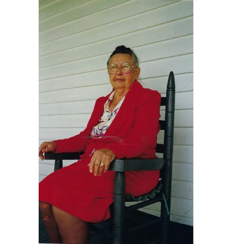 Polly McGuire sits in a rocking chair on the porch of her home that her father built in 1912. She was a beloved school teacher in Andrews for 40 years and died Nov. 3, 2003. 