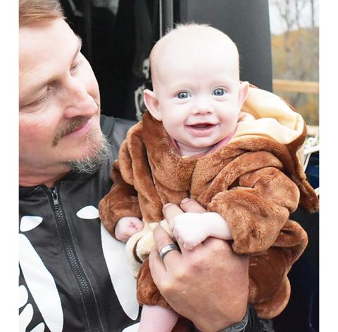 Photos by Anngee Quinones-Belian/Staff Correspondent Pastor Keith Mashburn of Culberson Baptist Church holds little flying monkey Malaya Lynn during the church’s Trunk or Treat event Saturday. 