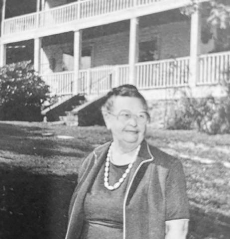 Polly McGuire stands in front of the Stewart House that her father built in 1912. Polly lived there all her life, but the house no longer stands on Stewart Road.