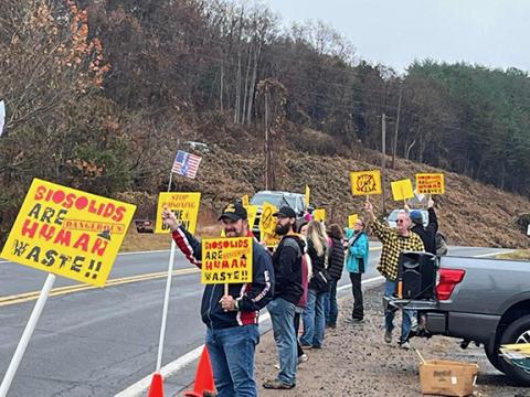 Citizens protesting the spread of biosolids and their smell are shown near the entrance to Copperhill Industries on the morning of Nov. 11. They were forced to move twice, despite permission from race officials to hold their event.