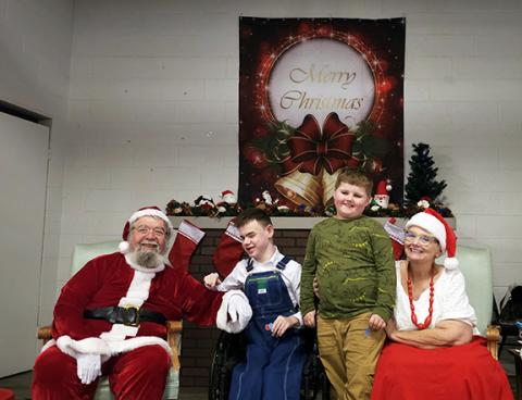 Photos by Nicole Wright/Staff Correspondent Conner and RayLynn Waldroup visit with Santa and Mrs. Claus at Cruise Night for the Kids’ final Christmas party. Over the last 16 years, thousands of gifts have been handed out.