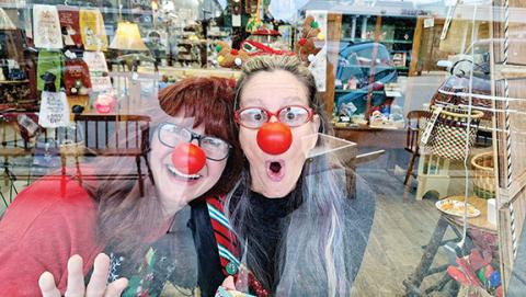 Photos by Bill Belian/Contributing Photographer  Cherokee County Commissioner Jan Griggs and Cherokee Scout humor columnist and Staff Correspondent Anngee Quinones-Belian played the part of living mannequins in the storefront window of Marketplace Antiques on Dec. 16. The act was presented to bring a bit more fun to the shopping experience. 