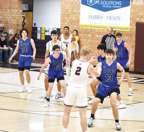 Photos by April McNabb/Contributing Photographer The Hiwassee Dam basketball teams split with Swain County on Dec. 5. The Lady Eagles beat the Maroon Devils 48-45, while the boys team lost 66-52.