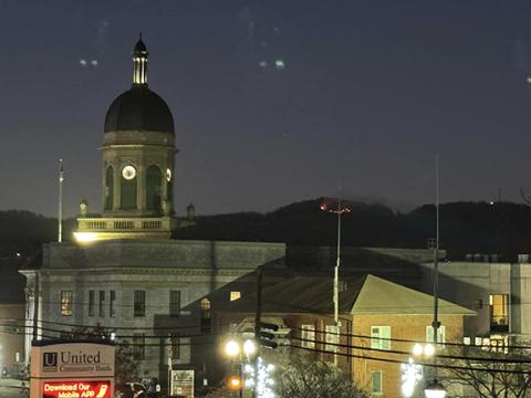 Trevis Hicks/Contributing Photographer A fire was reported Thursday on Fain Mountain near the Tanglewood development in Murphy. Both U.S. and N.C. Forest Service personnel worked to quickly extinguish the flames, which are barely visible at right beyond the Cherokee County Courthouse.