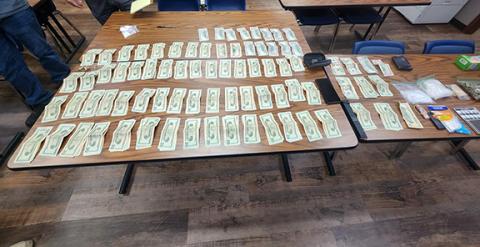 Tables hold drugs, weapons and cash seized by Cherokee County Sheriff’s Office deputies following a drug arrest on Dec. 4.