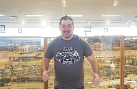 Photos by Nicole Wright/Staff Correspondent New manager Paul Disporto Jr. stands in front of a massive train display at the Great Smoky Mountain Railroad Museum in Bryson City. 