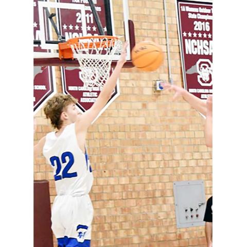 Kirk Headley/Contributing Photographer Dawson Headley, a 6-foot, 6-inch tall senior at Hiwassee Dam, blocks a shot during the Swain County Christmas Tournament last week.