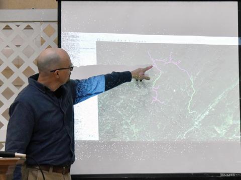 Bill Belian/Contributing Photographer Project engineer Gary Smith shows areas that will receive high-speed broadband fiber service in a meeting at the Unaka Community Development Club on Saturday.