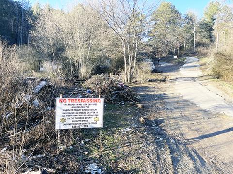 Randy Foster/editor@cherokeescout.com Warning signs were placed outside this property in Martins Creek that is being seized as a nuisance to the community.
