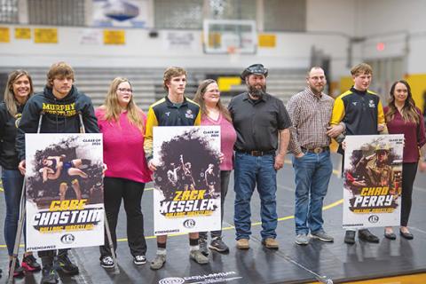 Sam Jokich/Staff Correspondent Murphy wrestlers Gabe Chastain, Zack Kessler and Chad Perry (from left, with their parents) were honored Friday during Senior Night.