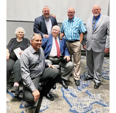 Longtime Swain County coach Boyce Dietz (sitting in middle) celebrates with his sister – along with Murphy coaches James Shope, Eric Brinke, Gary Thompson and Rick Hinke – during his N.C. High School Athletic Association Hall of Fame induction on Aug. 19, 2023.