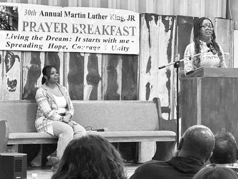 David Brown/dbrown@cherokeescout.com Farah Hall Eller (at podium) powerfully sings a gospel song accapella Monday morning during the 30th annual Martin Luther King Jr. Prayer Breakfast at the Texana Community Center. Event emcee Dawn Colbert is at left.