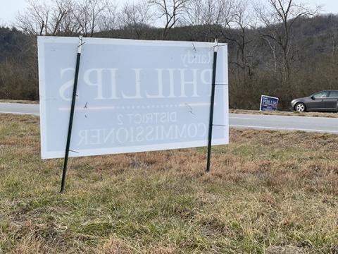 Cherokee County Commissioner Randy Phillips’ campaign signs placed in the right-of-way on both sides of U.S. 19/74/129 near Western Carolina Regional Airport appear to violate state law, which allows placement of campaign signs no sooner than 30 days before one-stop voting begins on Feb. 15.