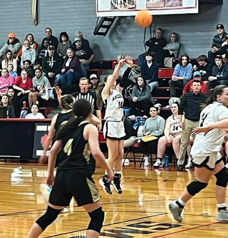 Jeff Tathum/Contributing Photographer Kylie Donaldson takes a shot for the Lady Wildcats.