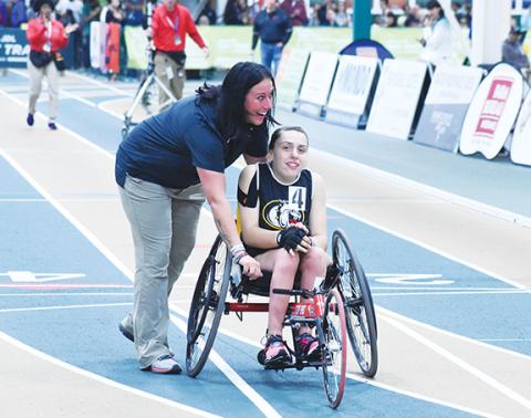 Photos by Kevin Hensley/The Graham Star Jordan Oliver (right) and Kristie Oliver (left) embrace after Jordan wins the state championship in the wheelchair 55-meter dash and sets her a new personal record Saturday at the N.C. High School Athletic Association Indoor Track State Championship.