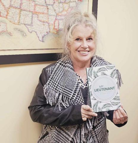 Nicole Wright/Staff Correspondent Sandy Reid, 69, of Murphy, proudly shows off her book My Lieutenant.