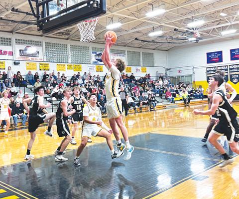 J.R. Carroll/Staff Correspondent Murphy’s Hunter Carson goes up for a score as Xander Wachacha looks on Feb. 13.