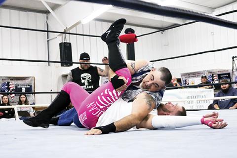 Cannon Crompton/sports@cherokeescout.com Mountain Man Jeremy Stiles pins Axel Gunn in the opening match of ACWF Valentine’s Massacre on Saturday night at the Peachtree Community Center.