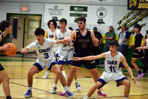 April McNabb/Contributing Photographer  Hiwassee Dam’s Aiden Bennett (left) and Kyle Taylor (right) defend the paint during the Little Smoky Mountain Championship game on Thursday