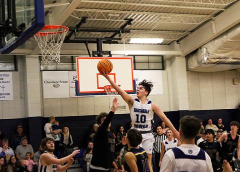 Cannon Crompton/sports@cherokeescout.com Nantahala’s Cole McCoy flies through the air to make a shot against Highlands on Friday night.