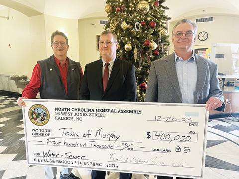Big time: From left, N.C. Sen. Kevin Corbin (R-Franklin), Murphy Mayor Tim Radford and state Rep. Karl Gillespie (R-Franklin) show off a $400,000 check to the town. The money will be used on the ongoing project to repair and replace Murphy’s aging water line.