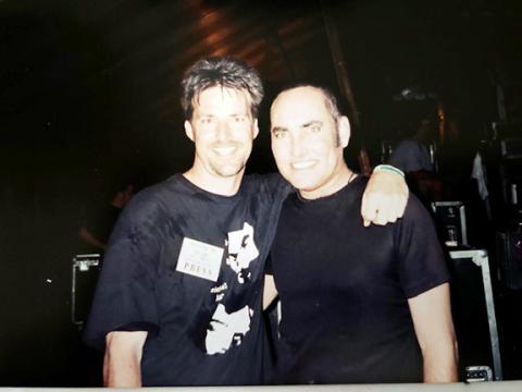 Michael Knott (right) hanging out with a newspaper publisher backstage at the Cornerstone Music Festival in 2002.