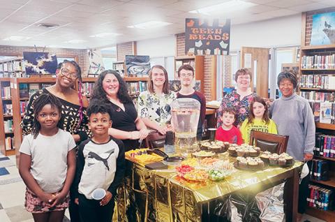 Nicole Wright/Staff Correspondent In front (from left) Thursday at the Andrews Public Library are Natalie George and Eli George. In back are Kristen George, Sarah Hardman; Shawn Hardman, Nathaniel Bressler, youth services librarian Bridget Wilson, Elliot Young, Autumn Young and Ann Miller Woodford, daughter of the late Purel Miller.