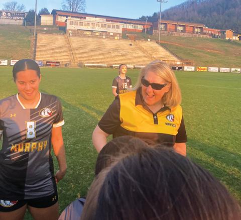 Donald Brownlee/ Assistant Coach Murphy girls head soccer coach Kim Brownlee celebrates one of her players’ birthdays with the team after a recent game.