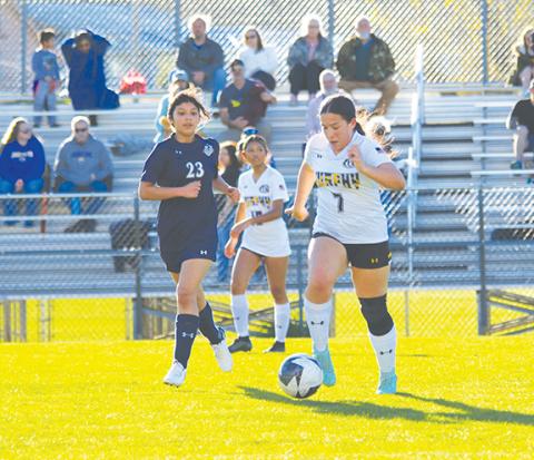 Cannon Crompton/sports@cherokeescout.com Isabel Parker (right) runs with the ball in their match against Tri-County Early College on March 11.