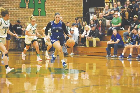April McNabb/Contributing Photographer Brinkley Payne of Hiwassee Dam runs up the court with the ball during the Lady Eagles’ state playoff game against Mountain Heritage on March 5.