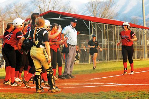 Photos by Cannon Crompton/sports@cherokeescout.com Pitcher Kinleigh Queen is met at home plate by her team after hitting a home run against Hayesville on Thursday.