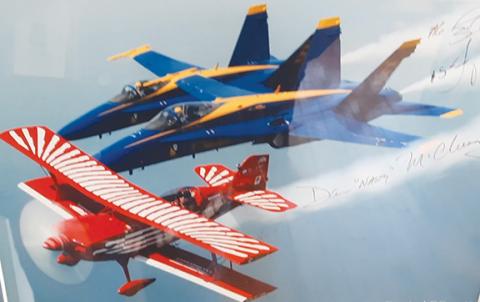 Photos by Anngee Quinones-Belian/Staff Correspondent  Displayed on a wall in Dan McClung’s shop are photos of the red-and-white aircraft he built and flew during air shows. His skills earned him the company of the Blue Angels.
