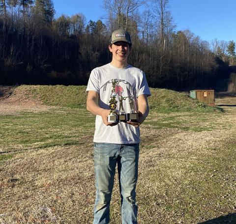Wendy Parker/Contributing Photographer Andrews High School junior Boone Parker holding his trophy from the Far West Shootout on Saturday, March 2 after shooting a nearly perfect 598/600.
