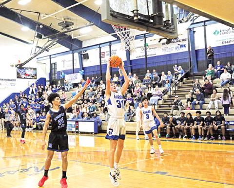Photos by Cannon Crompton/sports@cherokeescout.com Jonah Hamby jumps to put the ball in the hoop in their 1A state playoffs first-round game Friday against Mountain Island Charter.