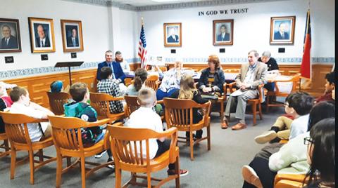 Photos by Anngee Quinones-Belian/Staff Correspondent  Nancy Helms of Ogreeta reads the book Beemer’s Adventures by author Jane Hembree of Murphy to a group of third-grade students from Peachtree Elementary School at Murphy City Hall on Thursday.