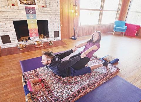 Nicole Wright/Staff Correspondent Massage therapist Renee Lamance and her husband, Zach Kilmer, practice stretching exercises as a form of therapy.