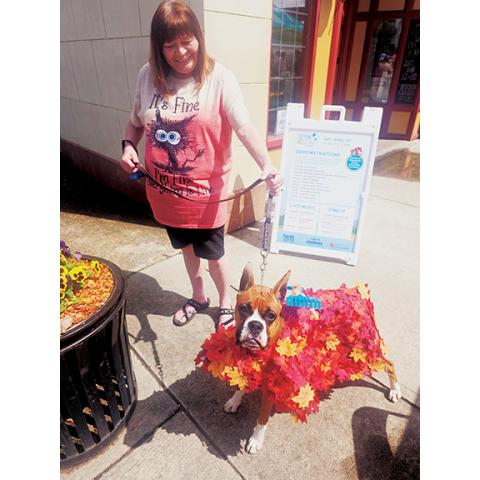 Nicole Wright/Staff Correspondent Although “doxies” were the dog of the day Saturday, Karrie Farmer and boxer Mercy D cleverly stole hearts as Dog in Pile of Leaves.