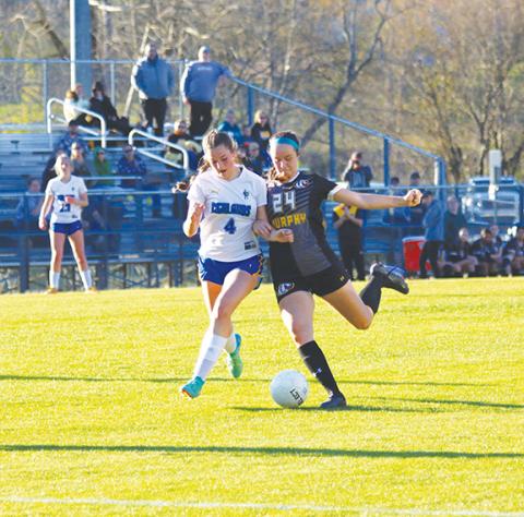 Cannon Crompton/sports@cherokeescout.com Murphy’s Lailee Holloway fights off a Highlands defender to take a shot on goal Thursday.