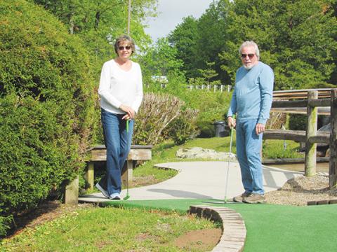  Chris Faries/Contributing Photographer Patty (left) and John Singer participate in the mini-golf tournament during last year’s Senior Games.