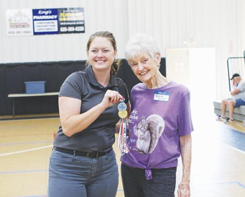 Cannon Crompton/sports@cherokeescout.com First-time Senior Games athlete Bonnie Motes, 88, of Murphy, celebrates her two medals in softball and football throws Saturday with Cherokee County Chamber of Commerce Executive Director Victoria Ivie.