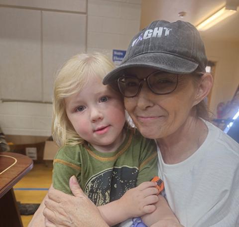 Nicole Wright/Staff Correspondent Kim Wackenhut is shown with one of her former Kids Corner of Peachtree day-care students, CJ, during Saturday’s fundraiser at Andrews United Methodist Church. Wackenhut is battling esophageal cancer, and her co-workers and family put on the benefit to help with medical costs and lost wages.