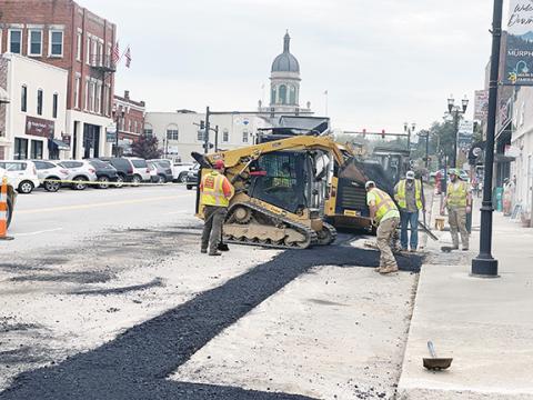 Randy Foster/editor@cherokeescout.com A road crew puts down new asphalt in downtown Murphy, where the four major streets will be repaved and meet at an intersection that will be reconfigured as a traffic circle.