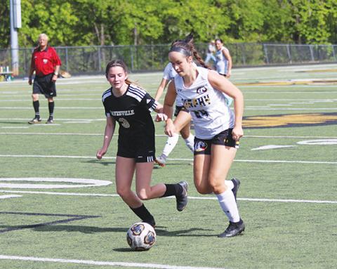Cannon Crompton/sports@cherokeescout.com Murphy senior Lailee Holloway holds off a Hayesville defender to make a run at the goal Thursday. 